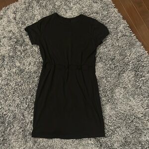 Black slightly bodycon dress with knot cut outs in front